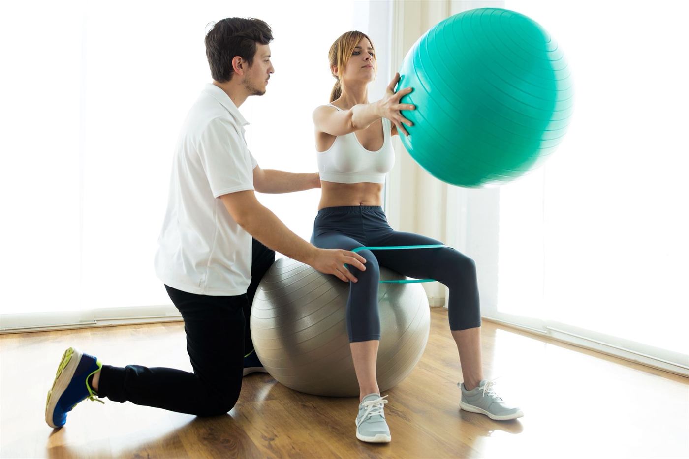 Betreute Krankengymnastik mit Gymnastikball und Übungsband